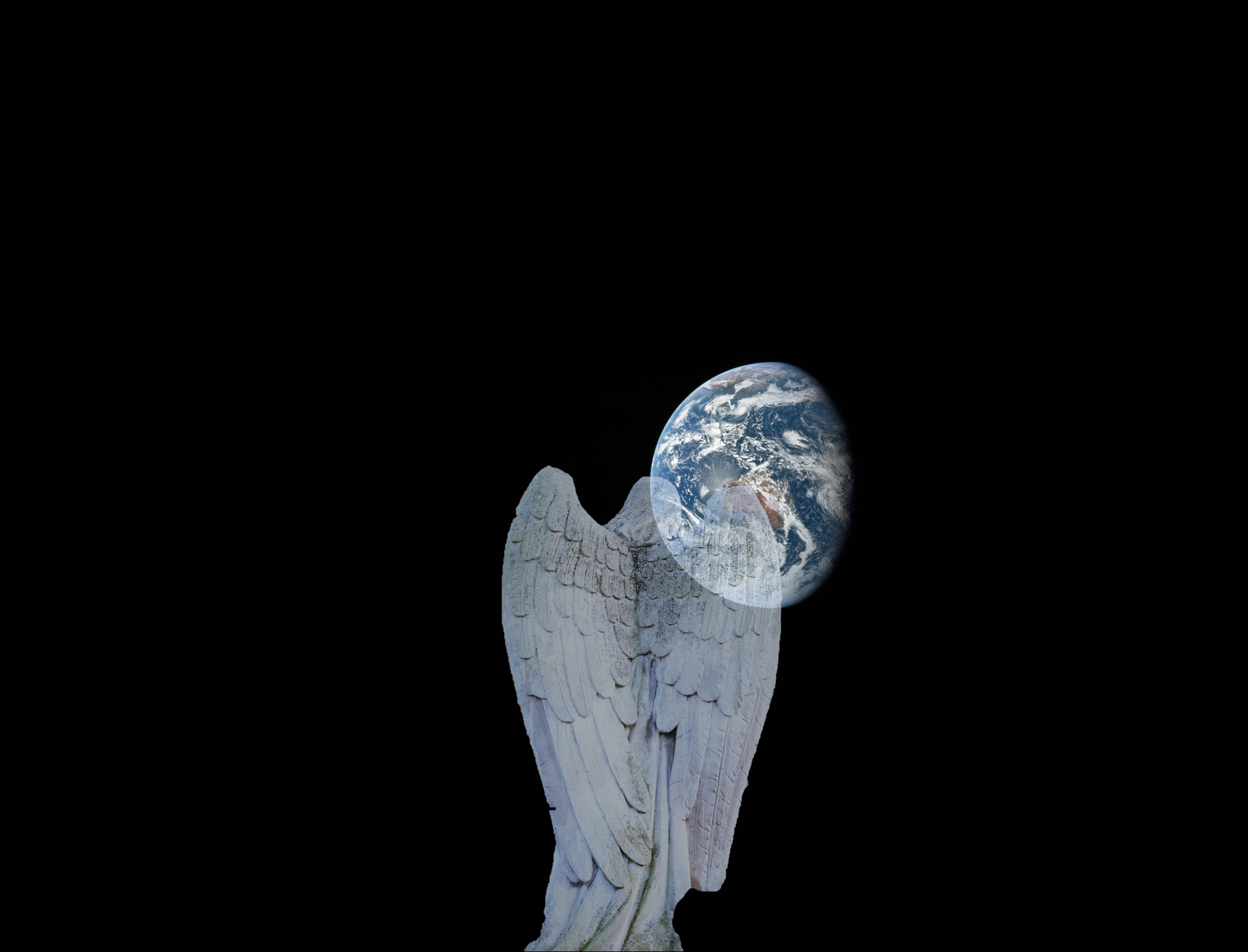 images of world and image of the back of an Angel with the Angel facing the Earth