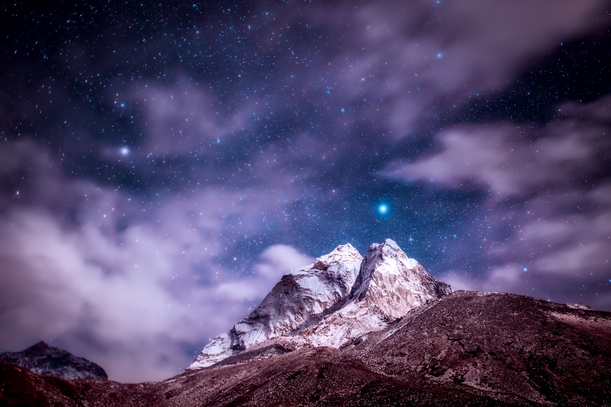 Himalayas mountains with blue starry sky white clouds