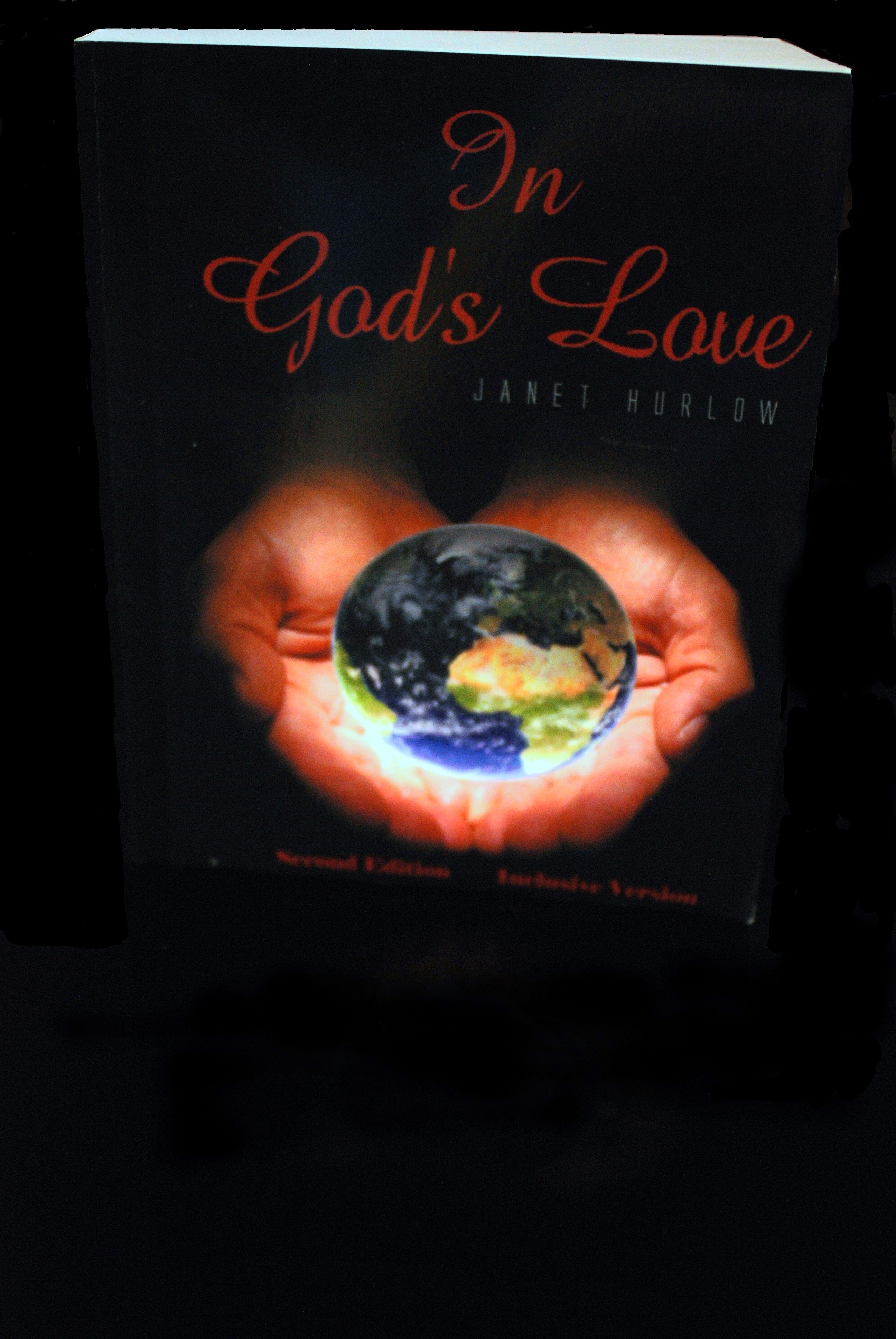 book image title In God's Love Second Edition Inclusive Version writer Janet Hurlow two hands holding the world